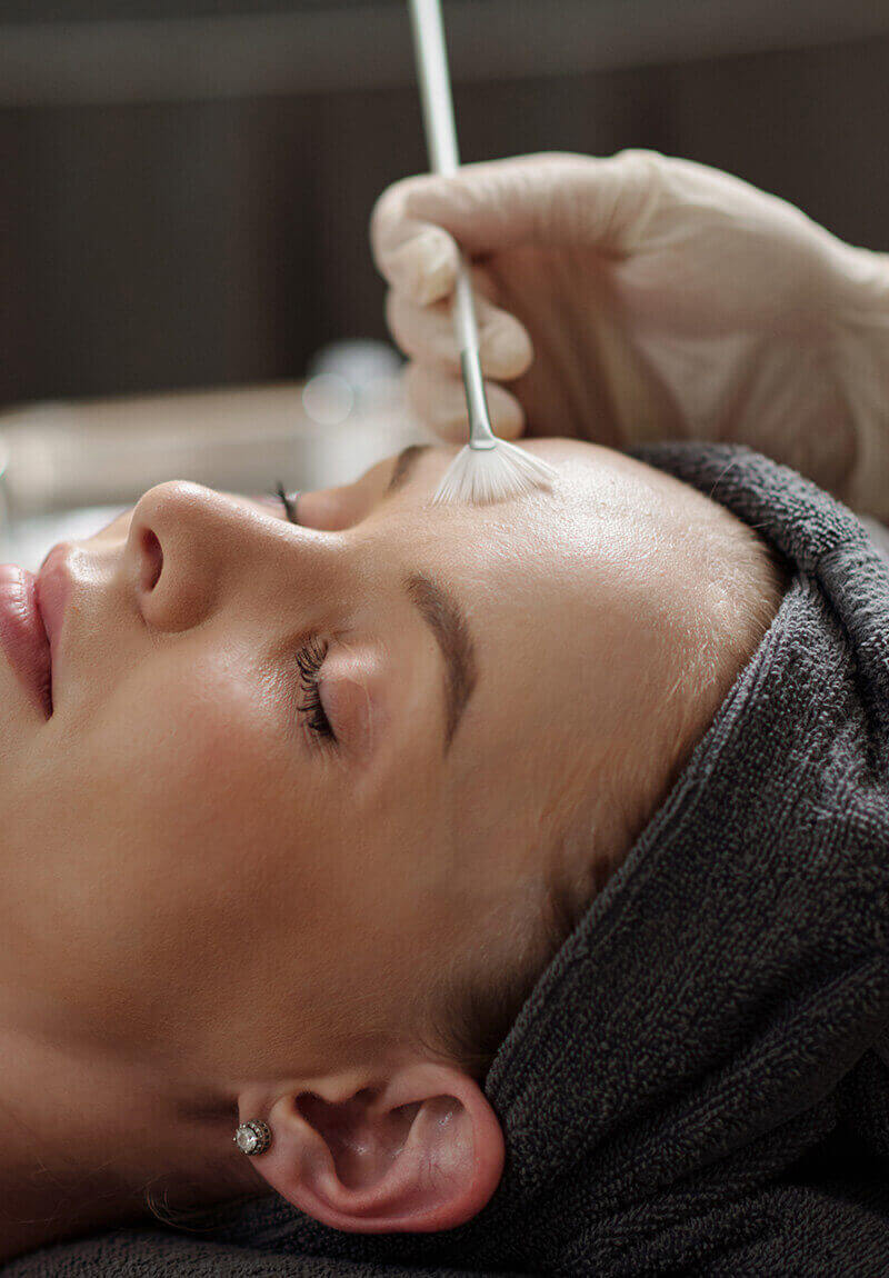 This is a picture of a woman getting a chemical peel. The chemical peel is a skin rejuvenation procedure that improves the appearance of the skin on the face, neck, or hands.