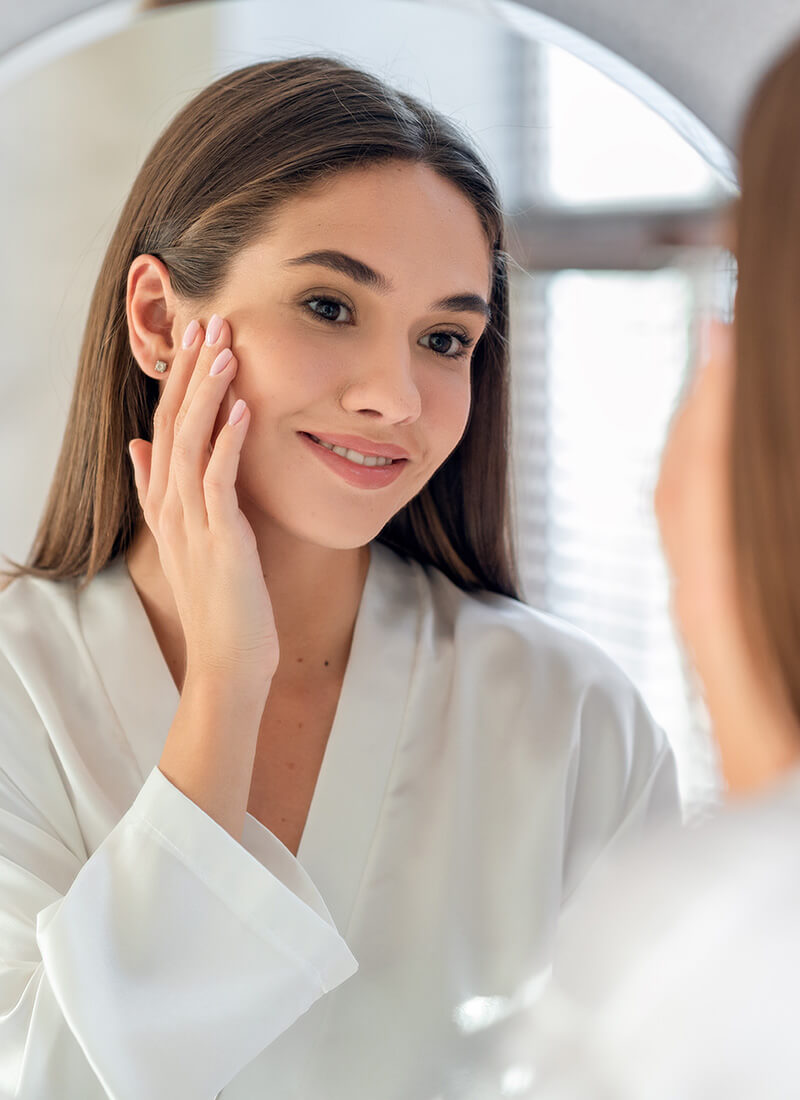 Woman looking at herself in the mirror