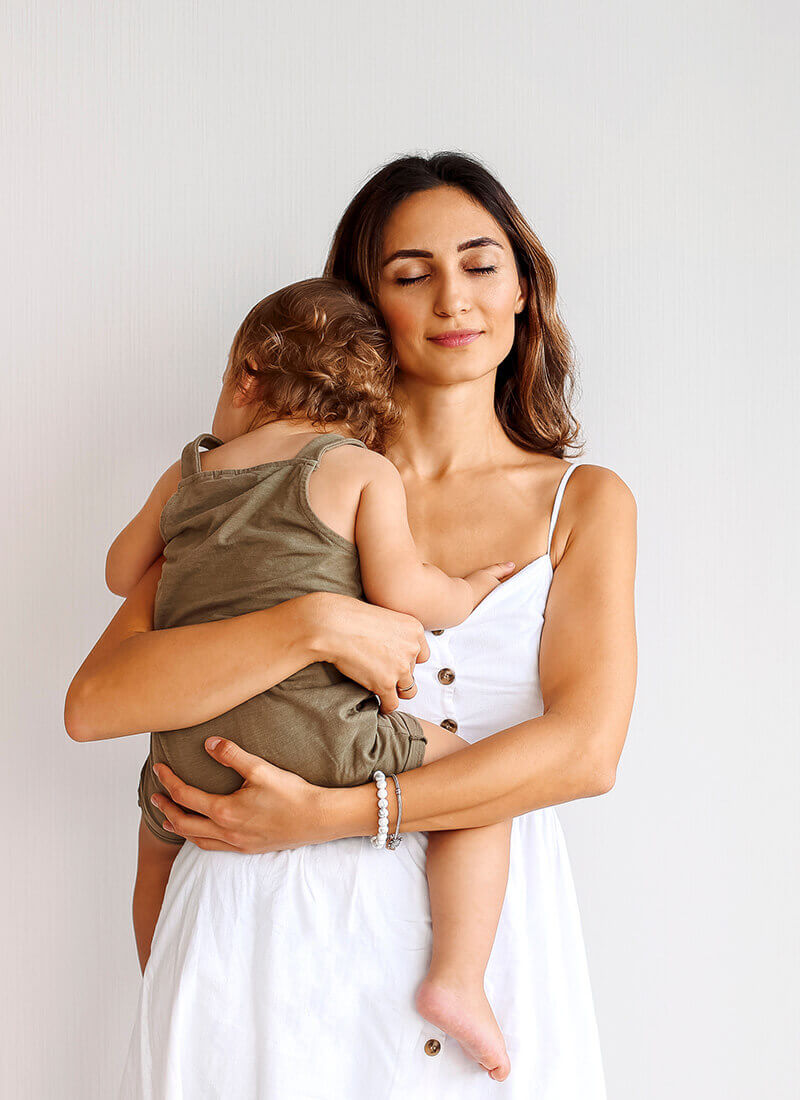 woman and child against a white wall