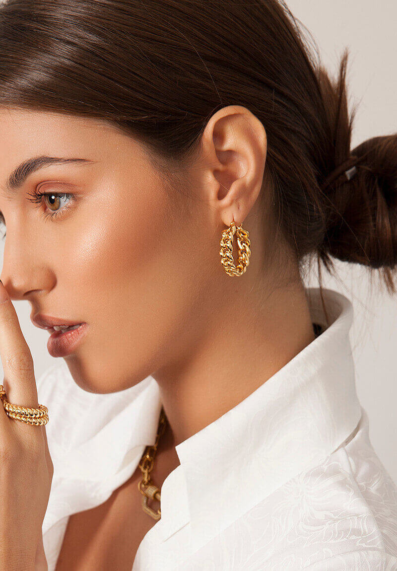 profile of a young woman with gold earrings