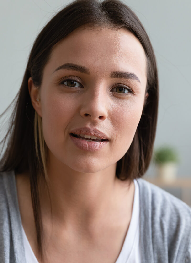 young woman in a gray sweater